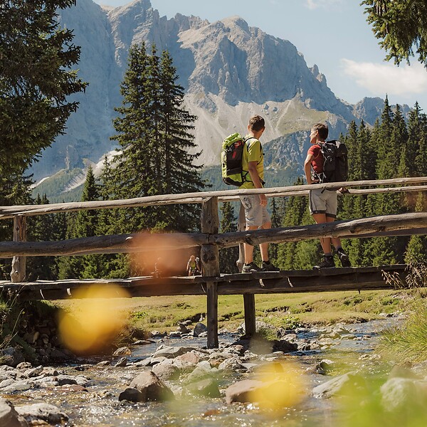 Two men hiking on trail near the Dolomites