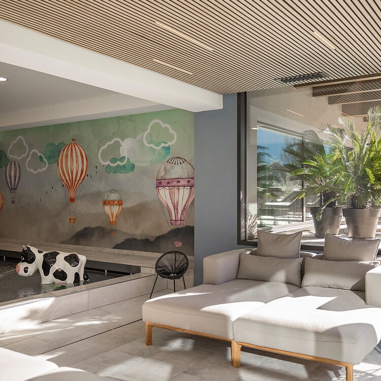 Indoor baby pool with large lounge chairs for adults