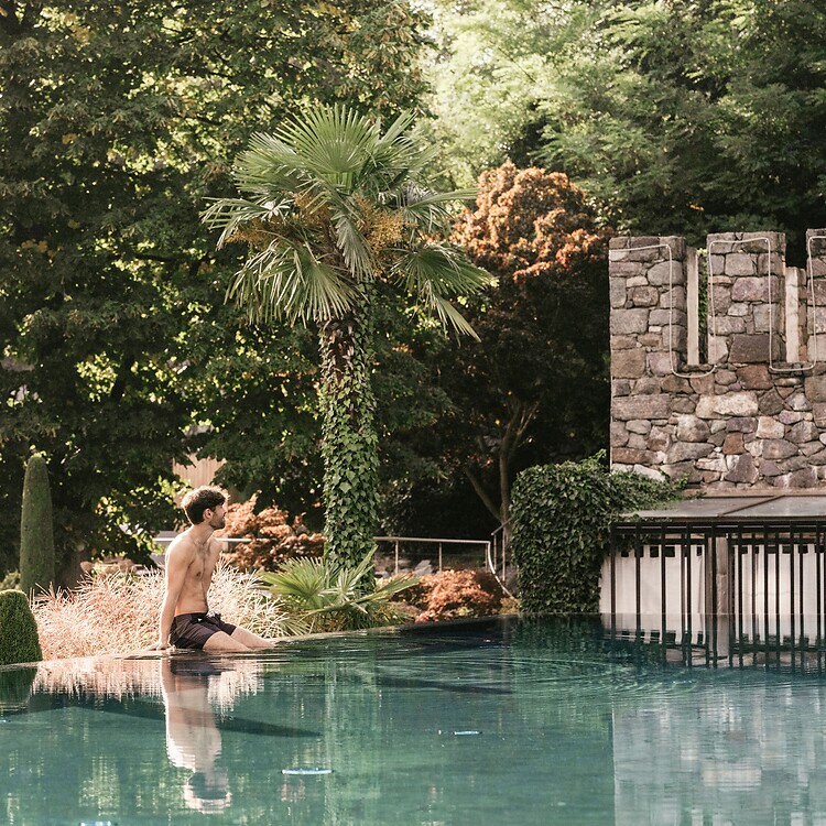 Man sitting by the sport pool in the garden