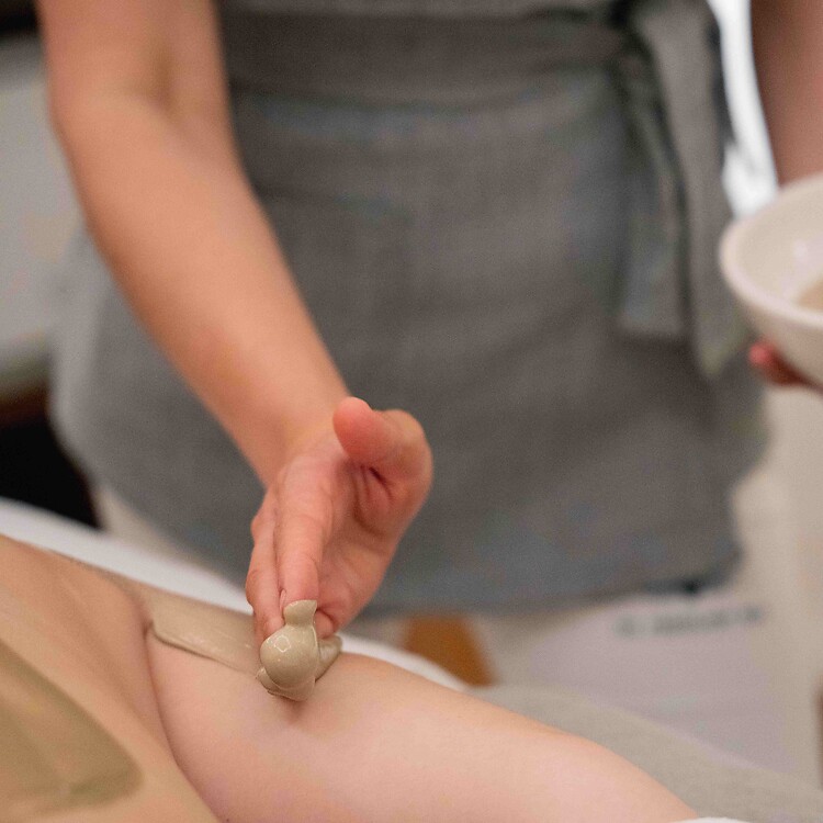 Woman during a wellness treatment with a thermal water product