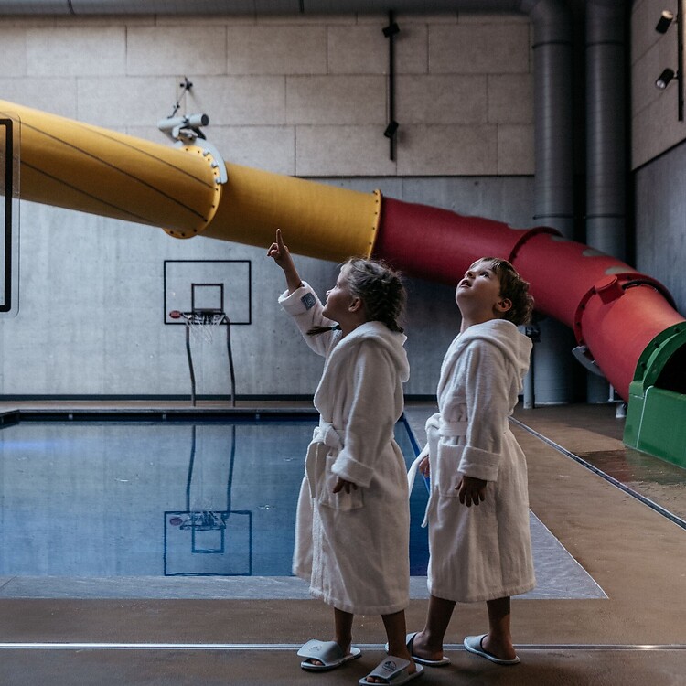 Bambini nella Family Spa con sullo sfondo il grande scivolo d’acqua