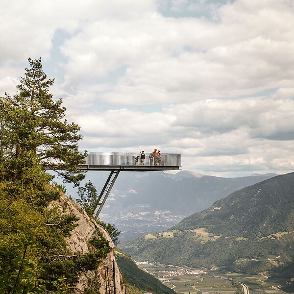 Family on the Unterstell viewpoint overlooking the Vinschgau valley and mountains