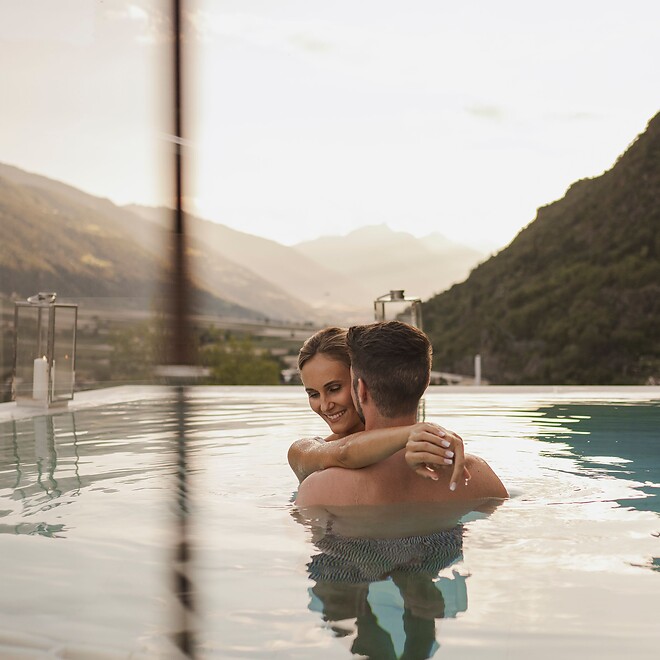Mann und Frau im romantischen Sky Sole Pool mit Kerzen