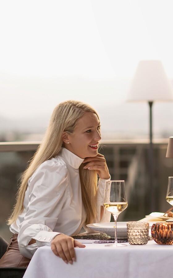 Woman and man at a beautifully set table with mountain views