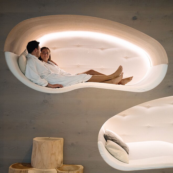 Man and woman relaxing on illuminated lounger