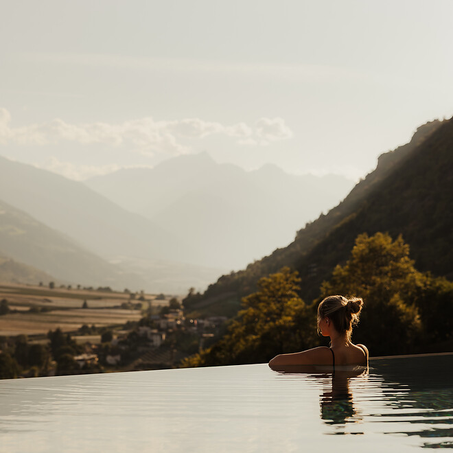 Frau im Infinity Sky Pool mit Bergblick