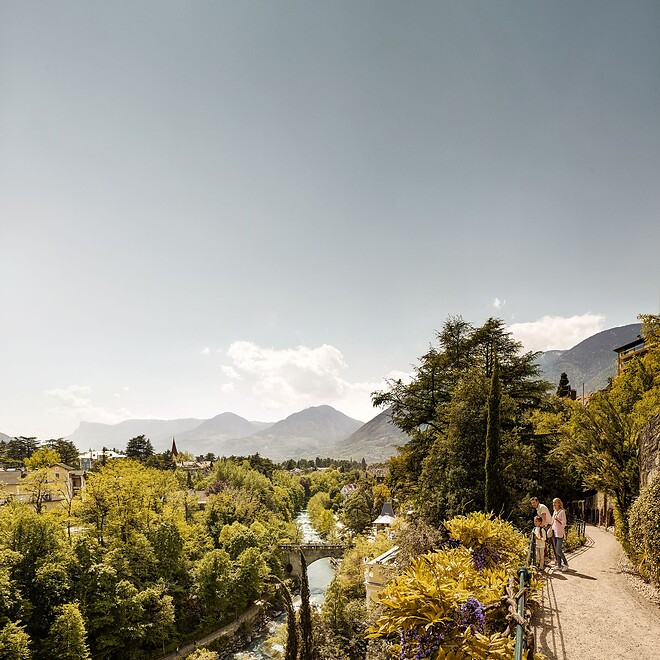 Family on panoramic trail in spa town Merano with mountain panorama