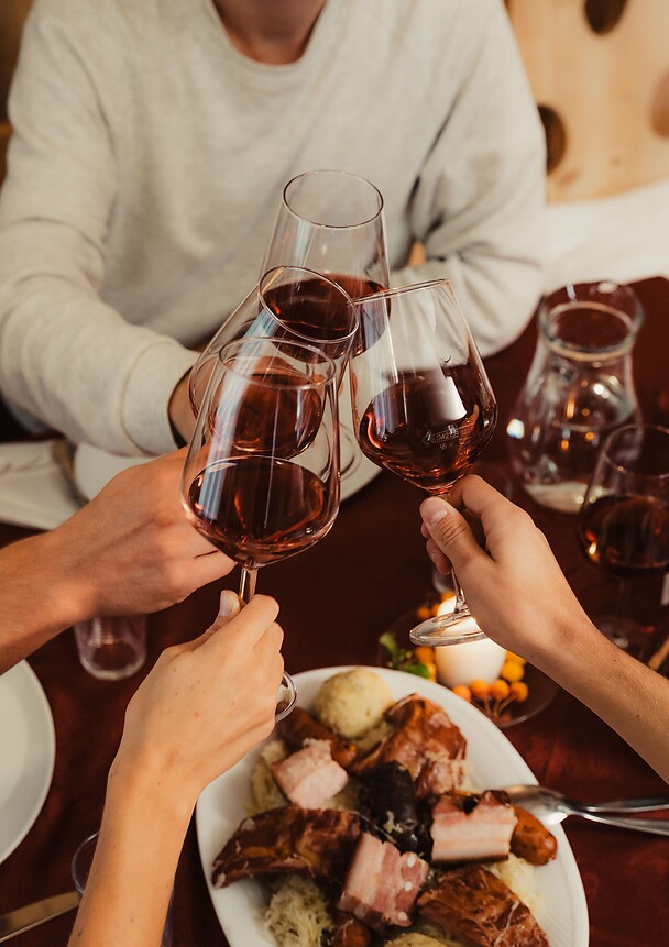 Toasting with a glass of red wine during Törggelen