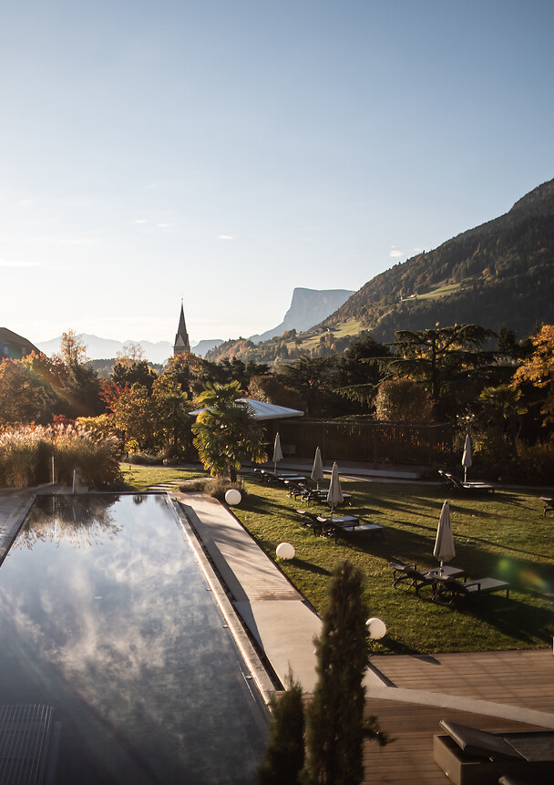 Outdoor infinity pool and hotel garden in autumn