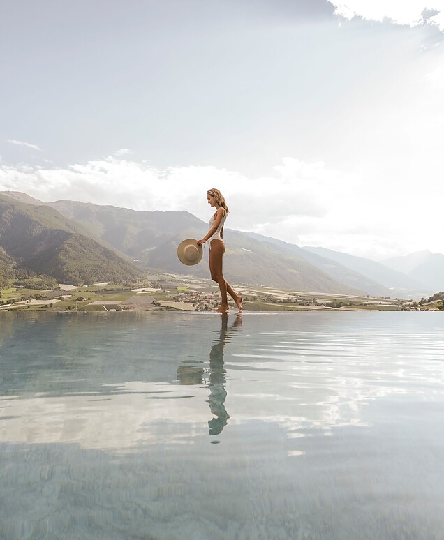 Woman walking along the Infinity Pool with panoramic view