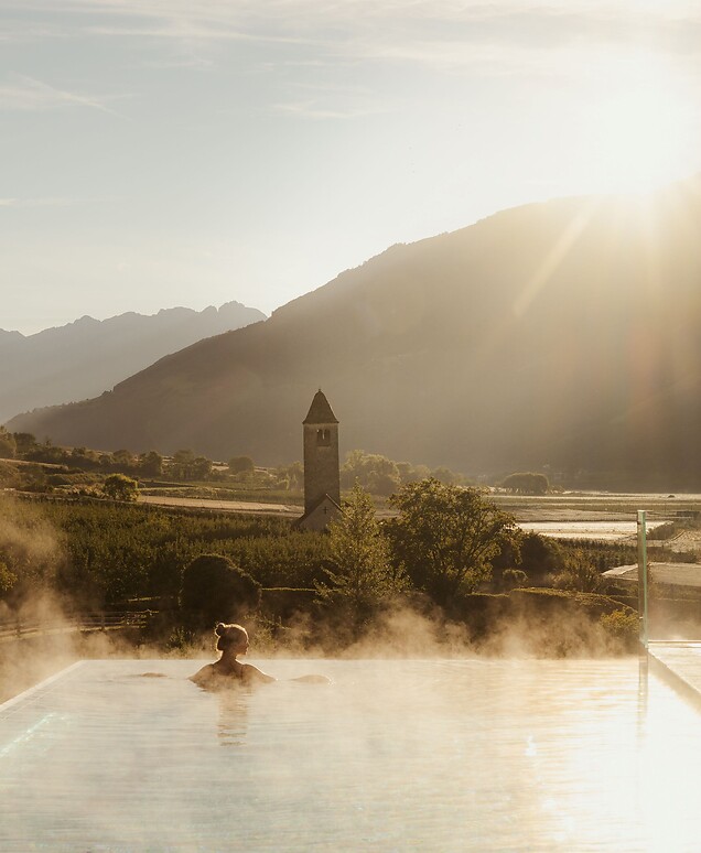 Woman enjoying the breathtaking view in the Infinity Skypool at sunrise