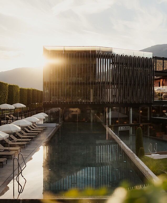 Wellness tower with sports pool and sun loungers at sunrise