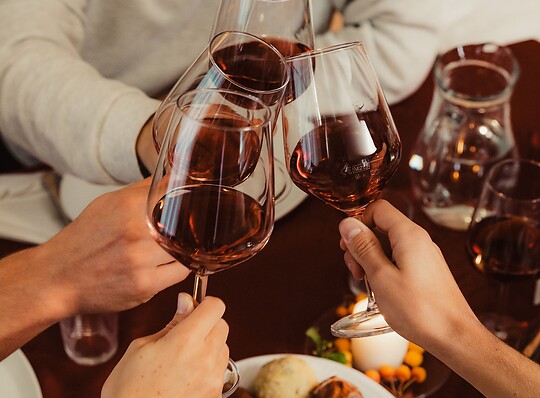 Toasting with a glass of red wine during Törggelen